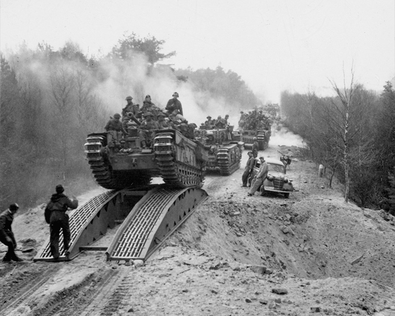 Churchill tanks of the 3rd Scots Guards crossing a bridged mine crater between Celle and the River Elbe, 14 April 1945